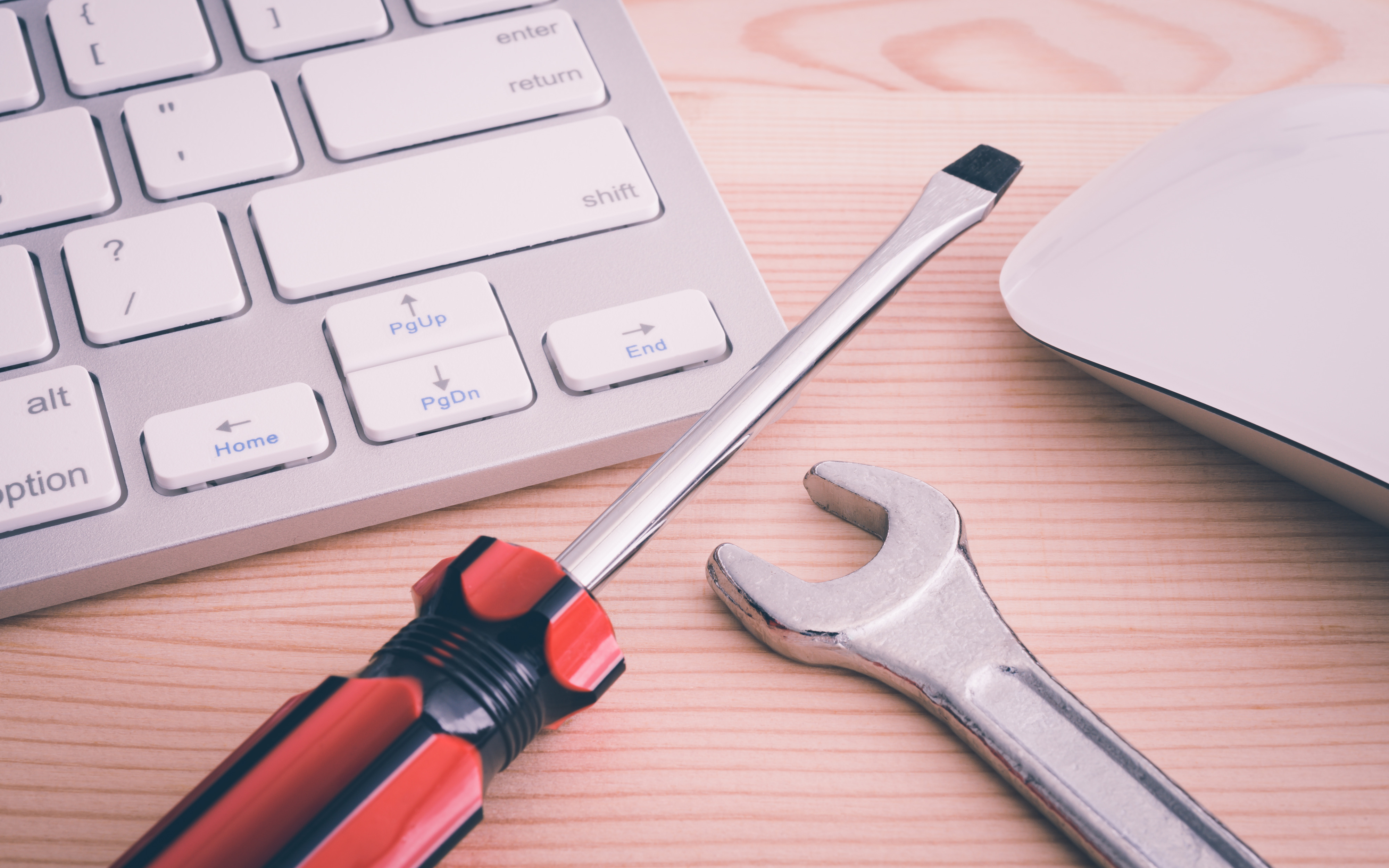 Desk With Keyboard, Screwdriver, and Wrench